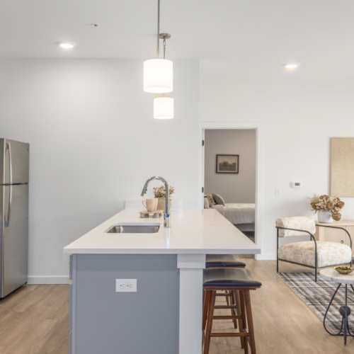 a kitchen with a stove and chairs